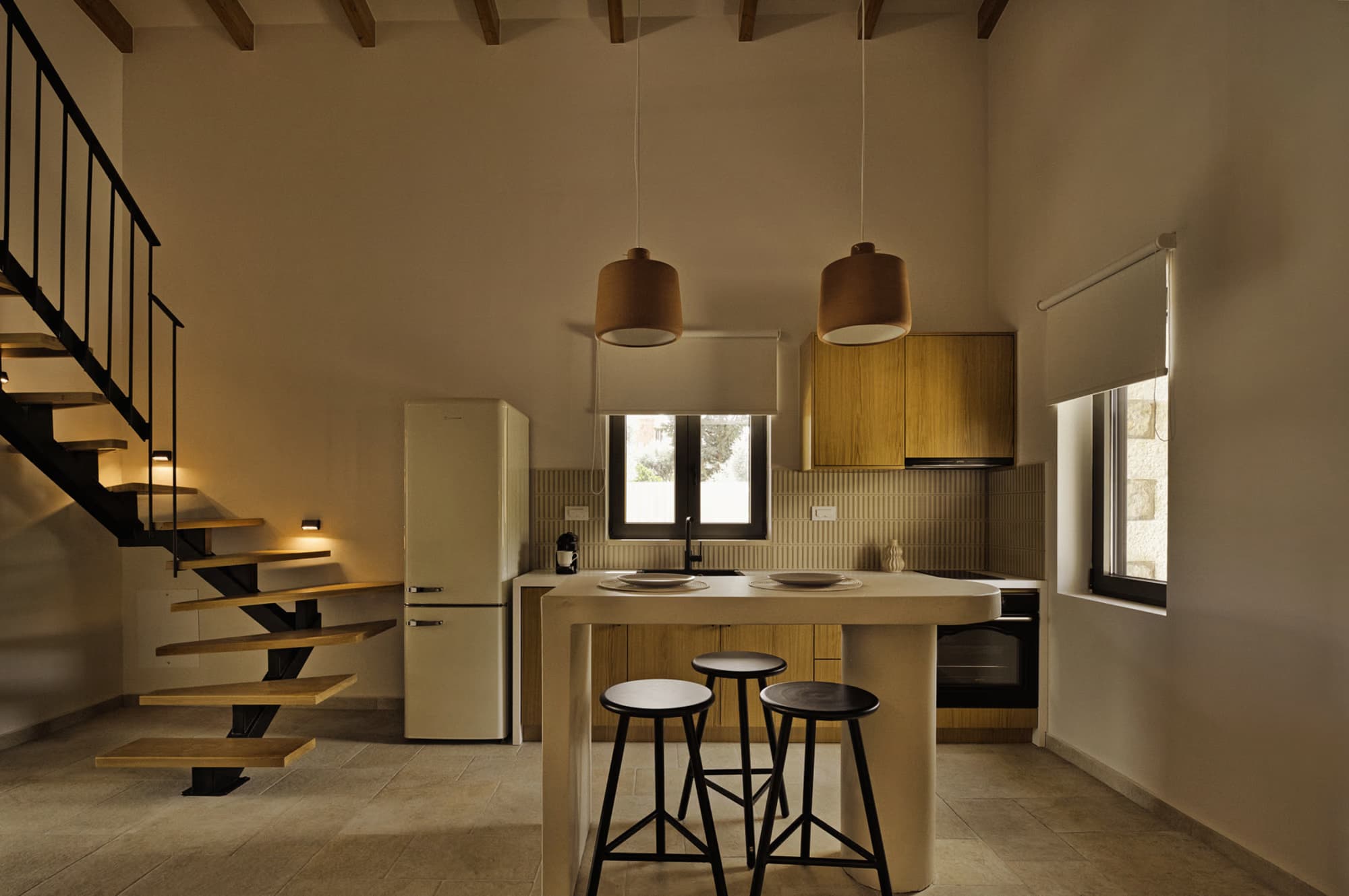 Revello Villa 1 kitchen with breakfast bar beneath the loft stair