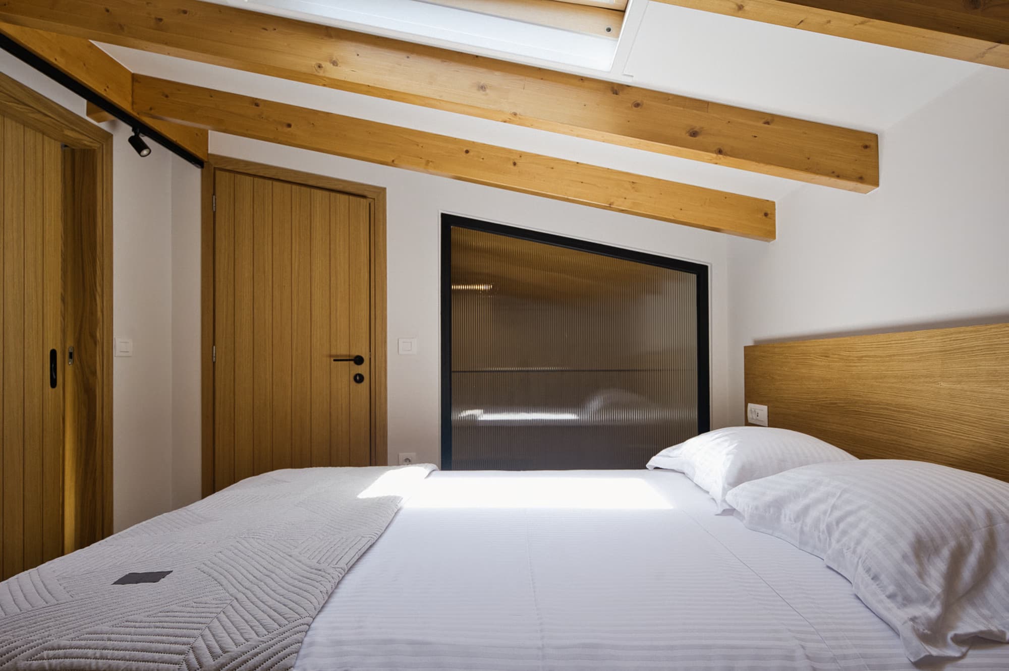 Revello Villa 1 loft bedroom under exposed timber beams