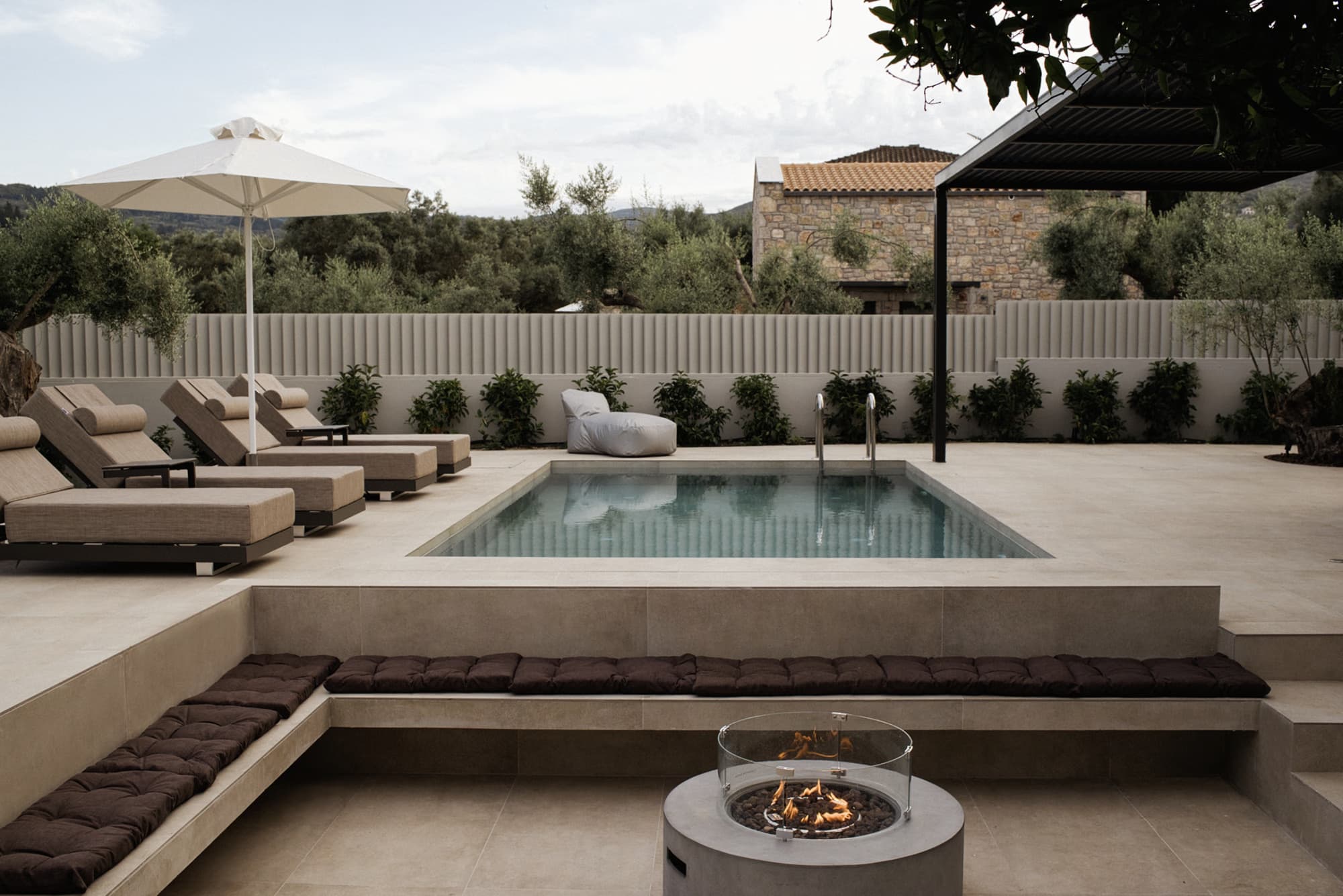 Revello Villa 1 pool terrace with loungers and shaded pergola