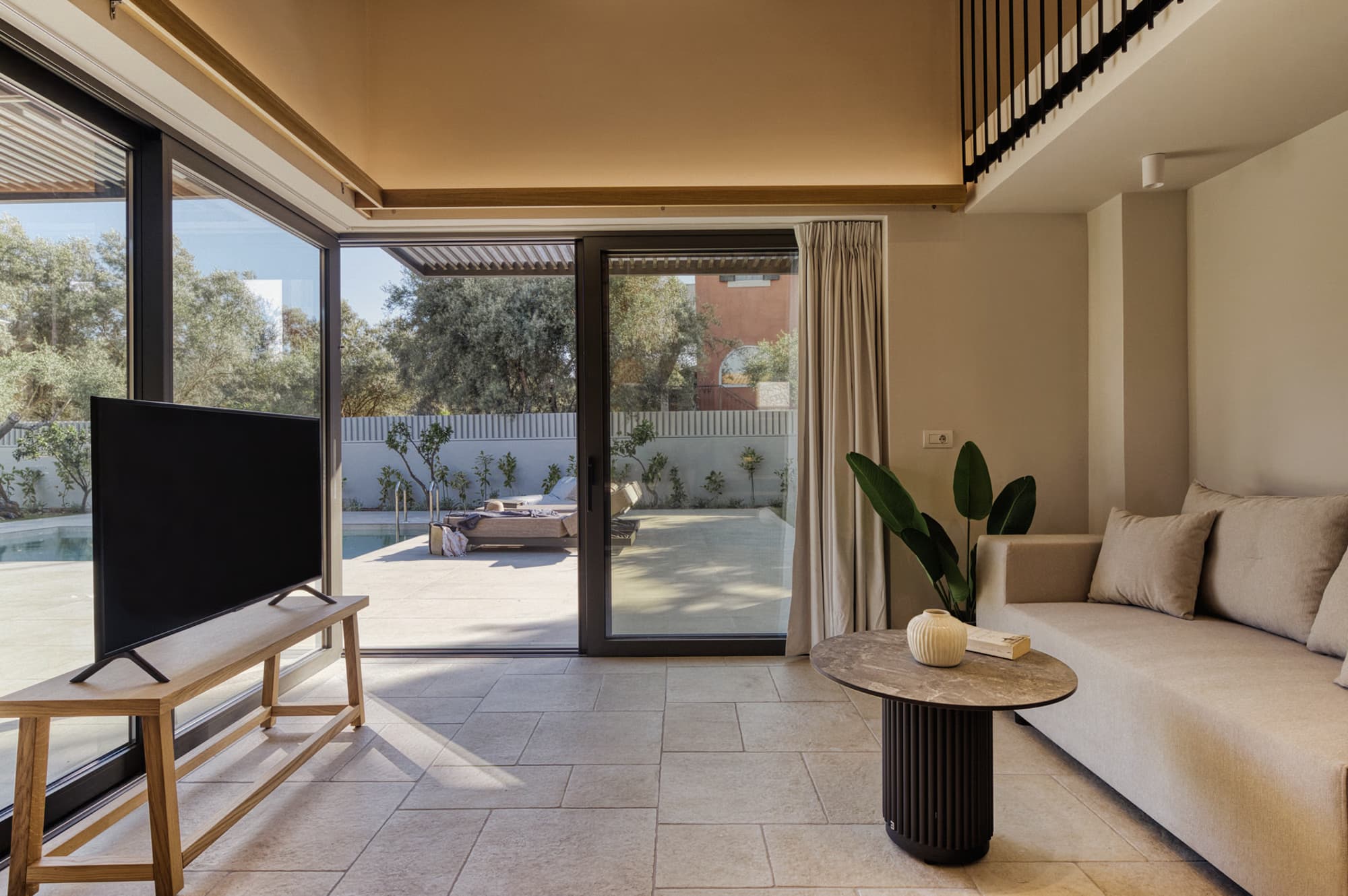 Revello Villa 2 living room with glass doors to the pool terrace