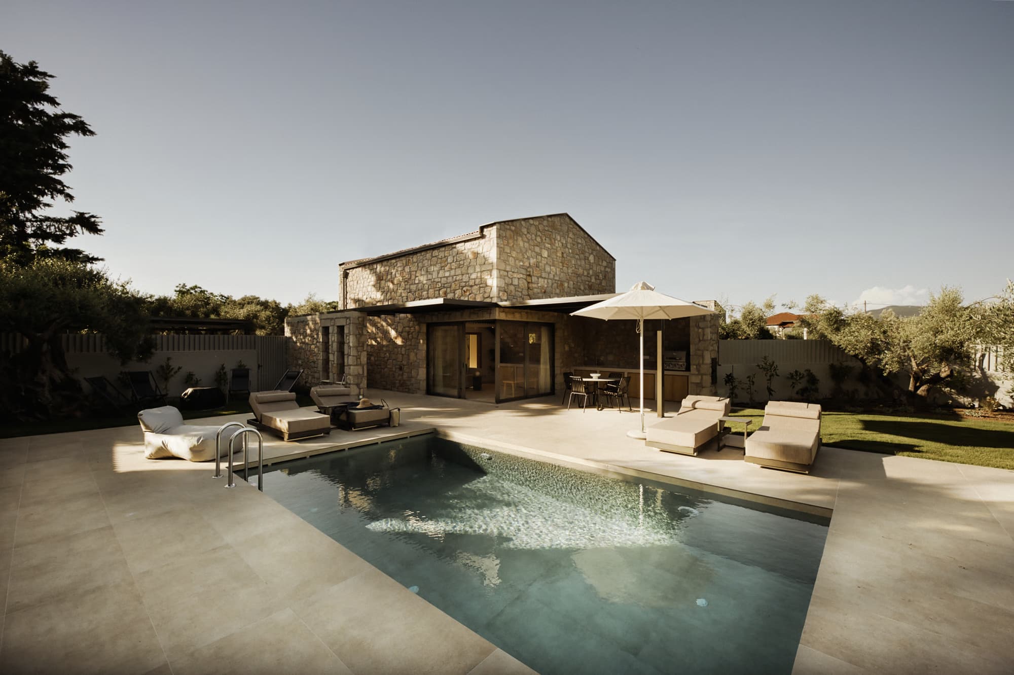 Revello Villa 2 pool and stone facade in evening light
