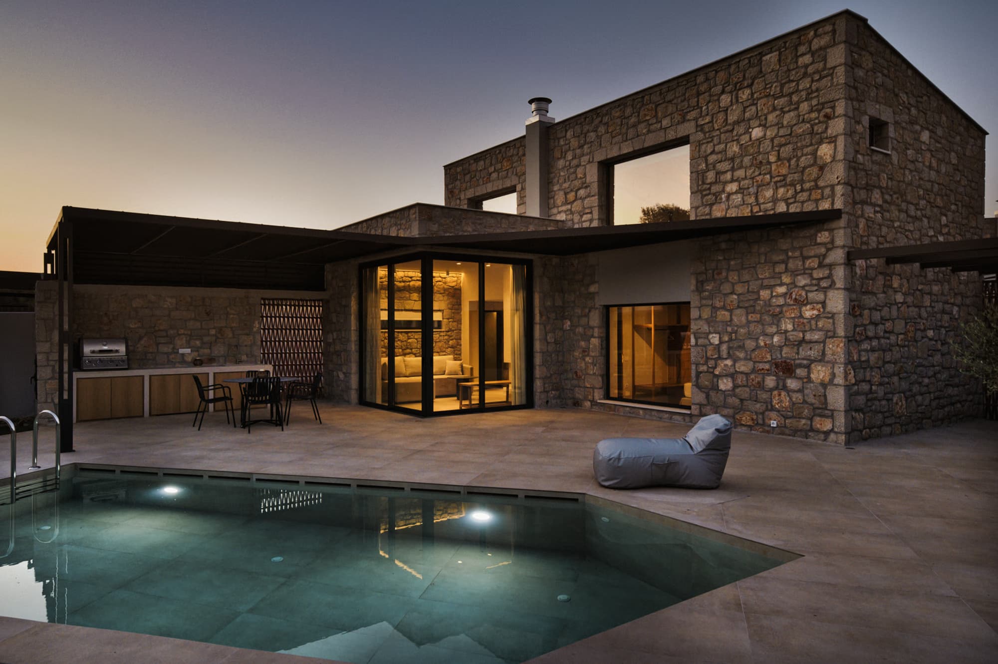 Revello Villa 3 stone facade and private pool at dusk