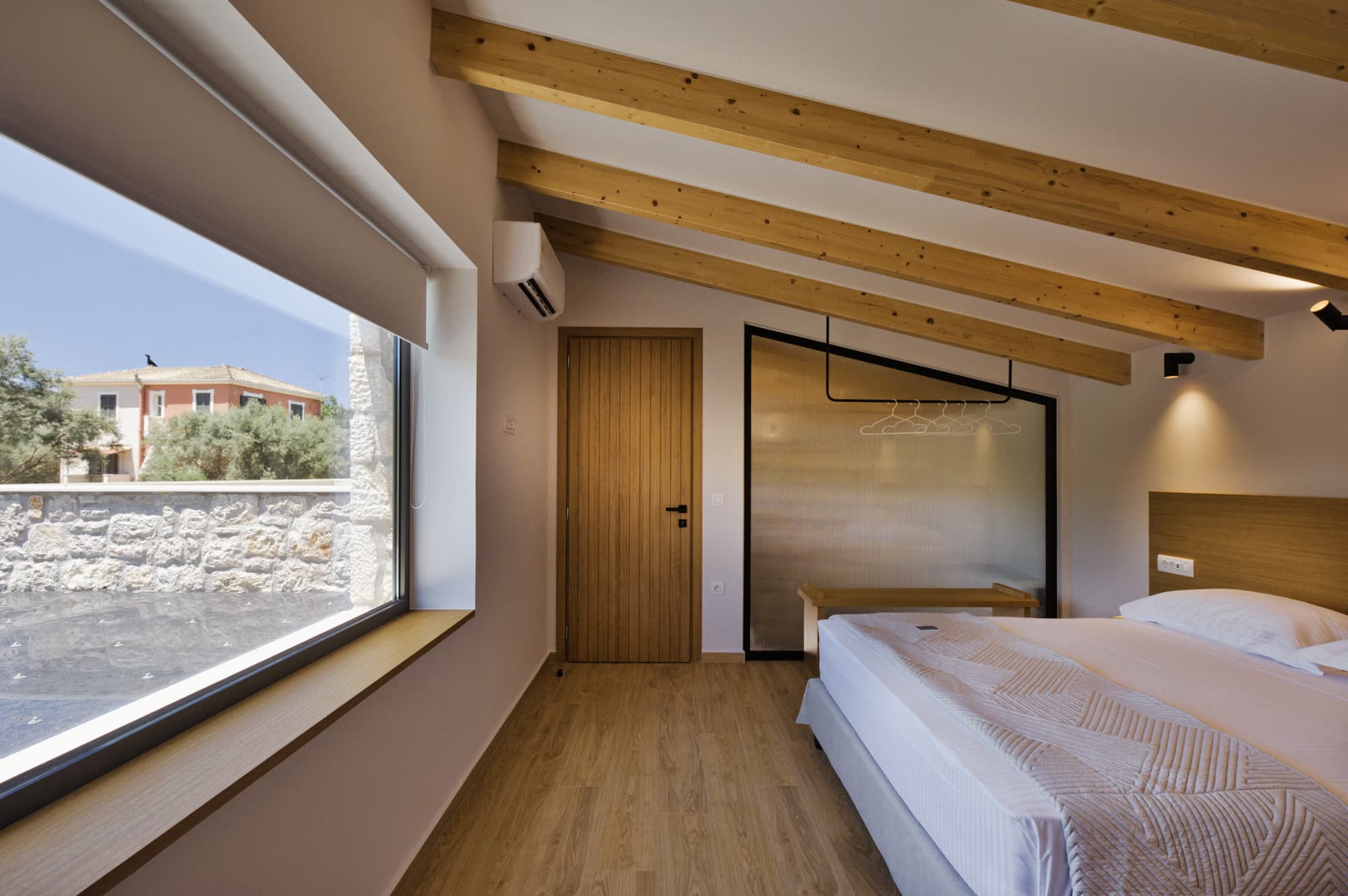 Revello Villa 3 beamed bedroom with a low picture window