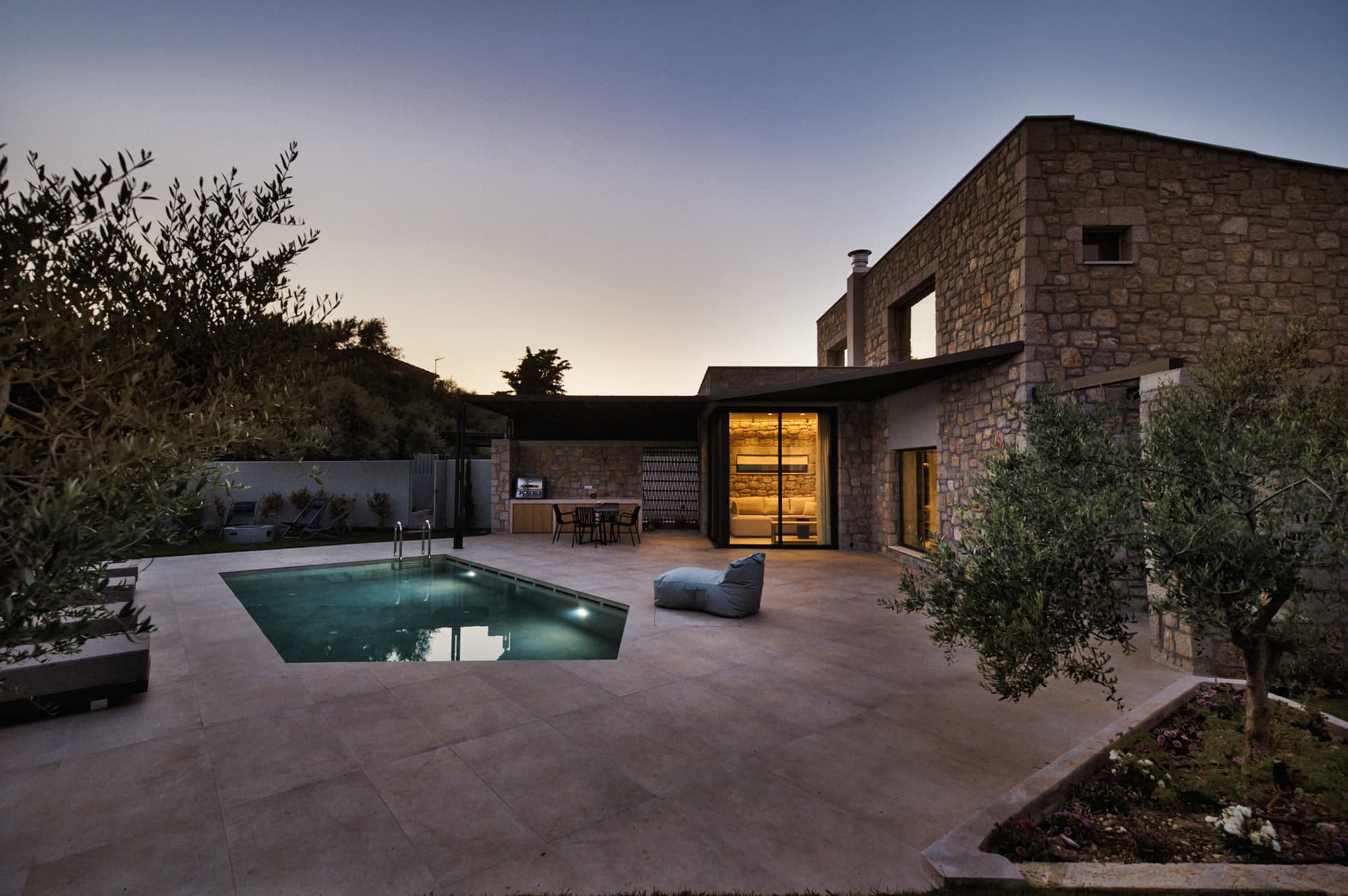 Revello Villa 3 pool and stone facade in the evening, Lefkada