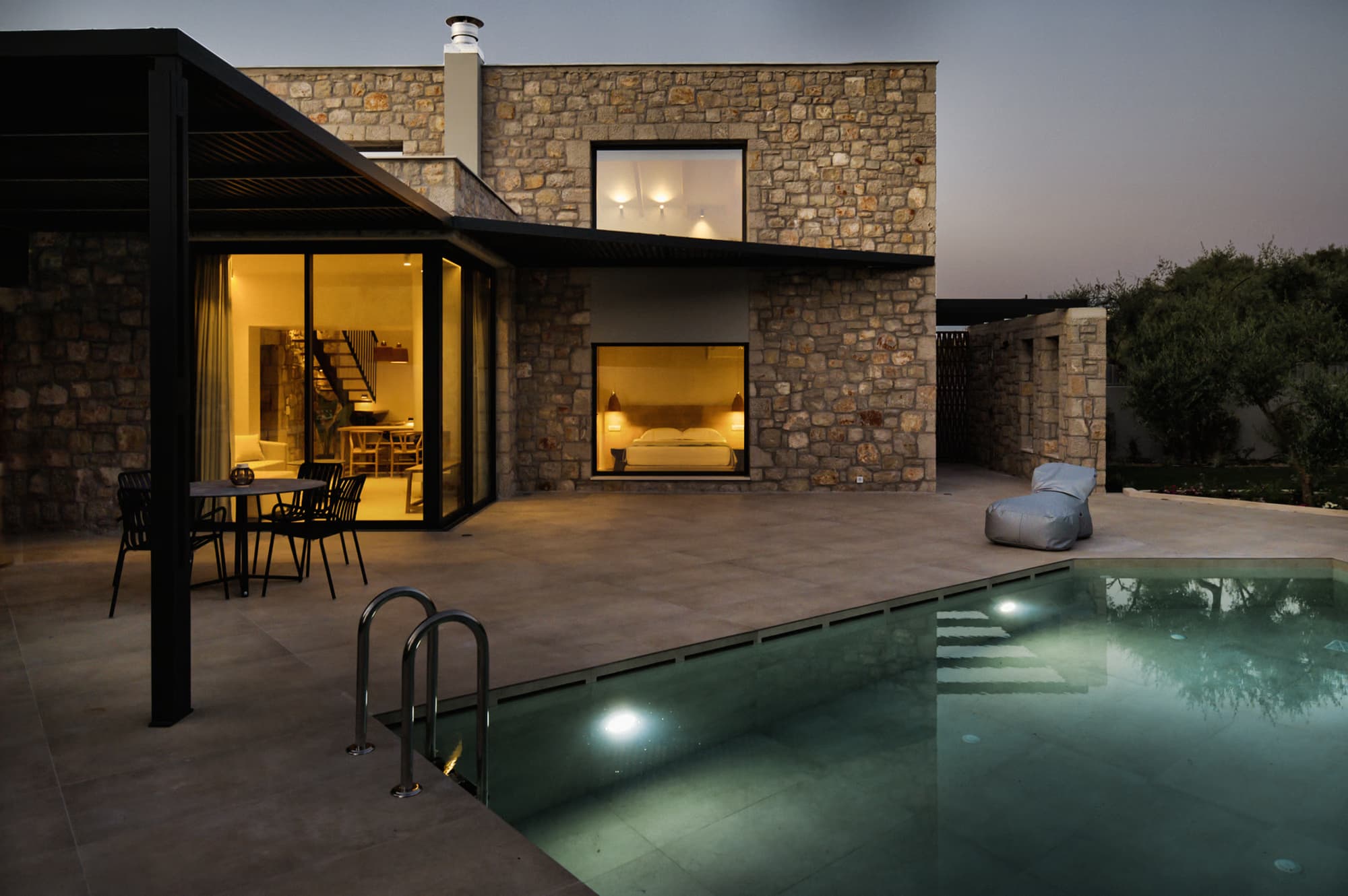 Revello Villa 3 pool terrace lit at night