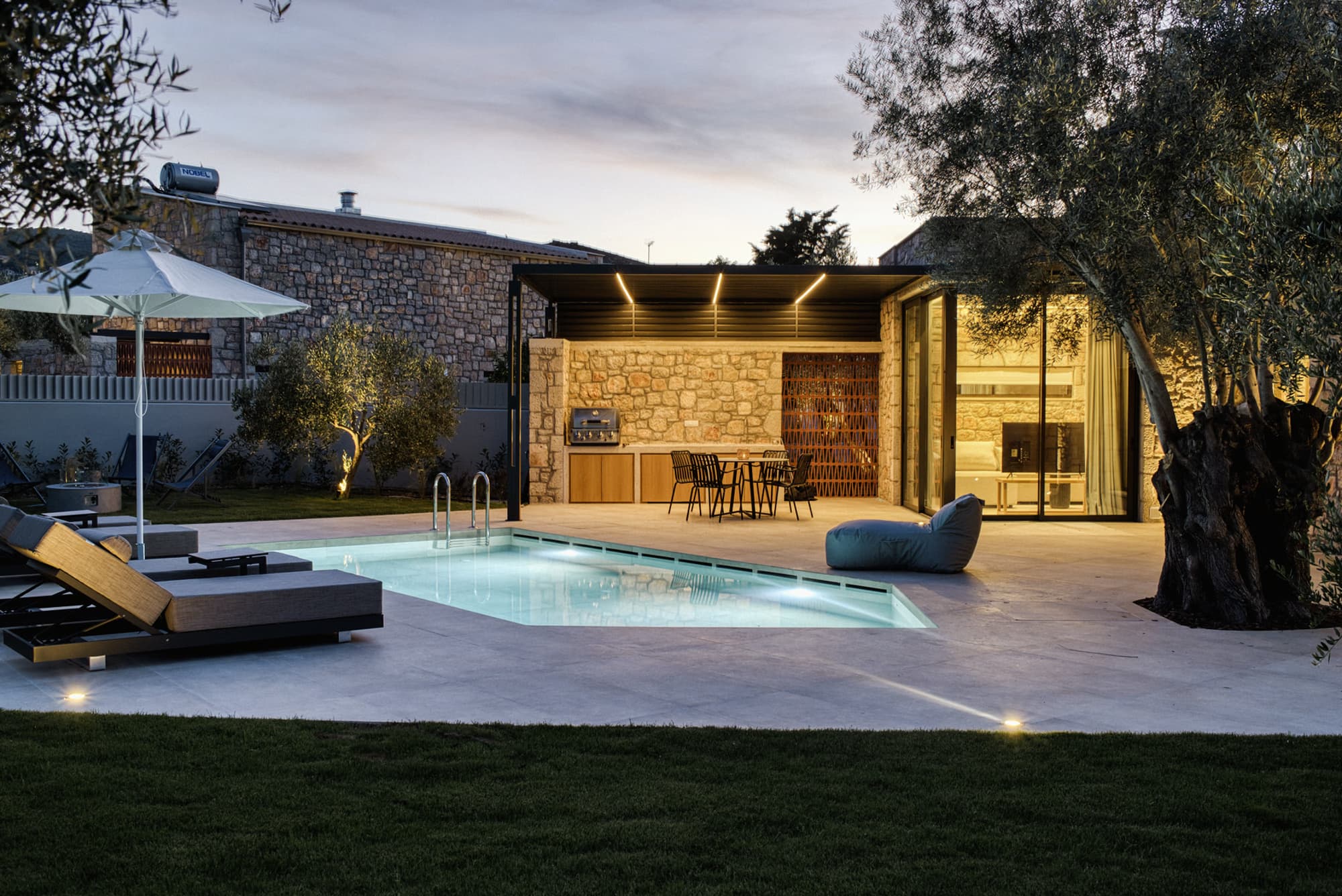 Revello Villa 4 pool and loungers at twilight